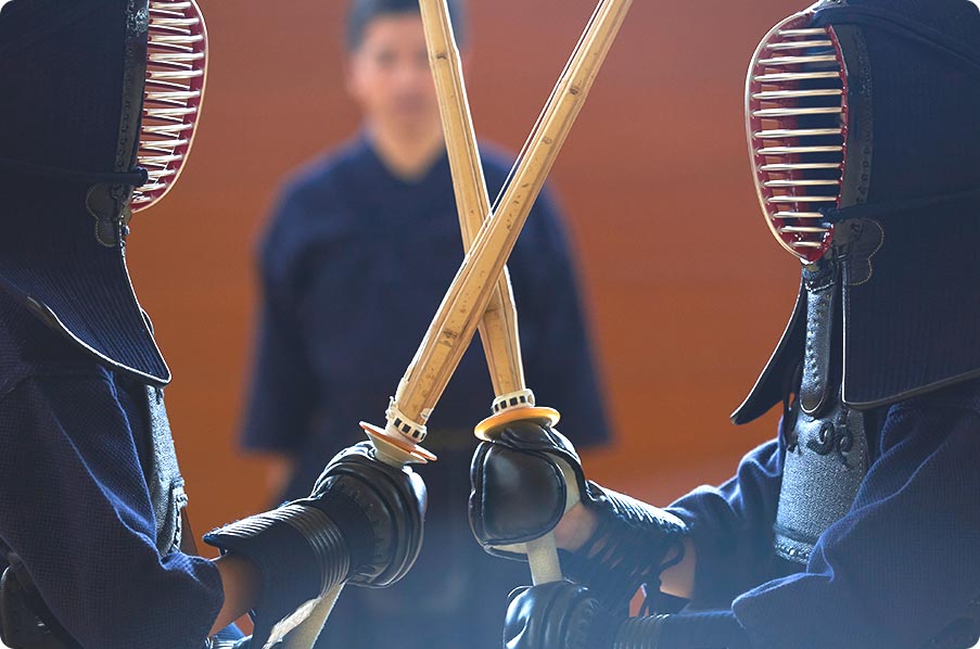 剣道の試合 鍔迫り合いを審判が見つめている